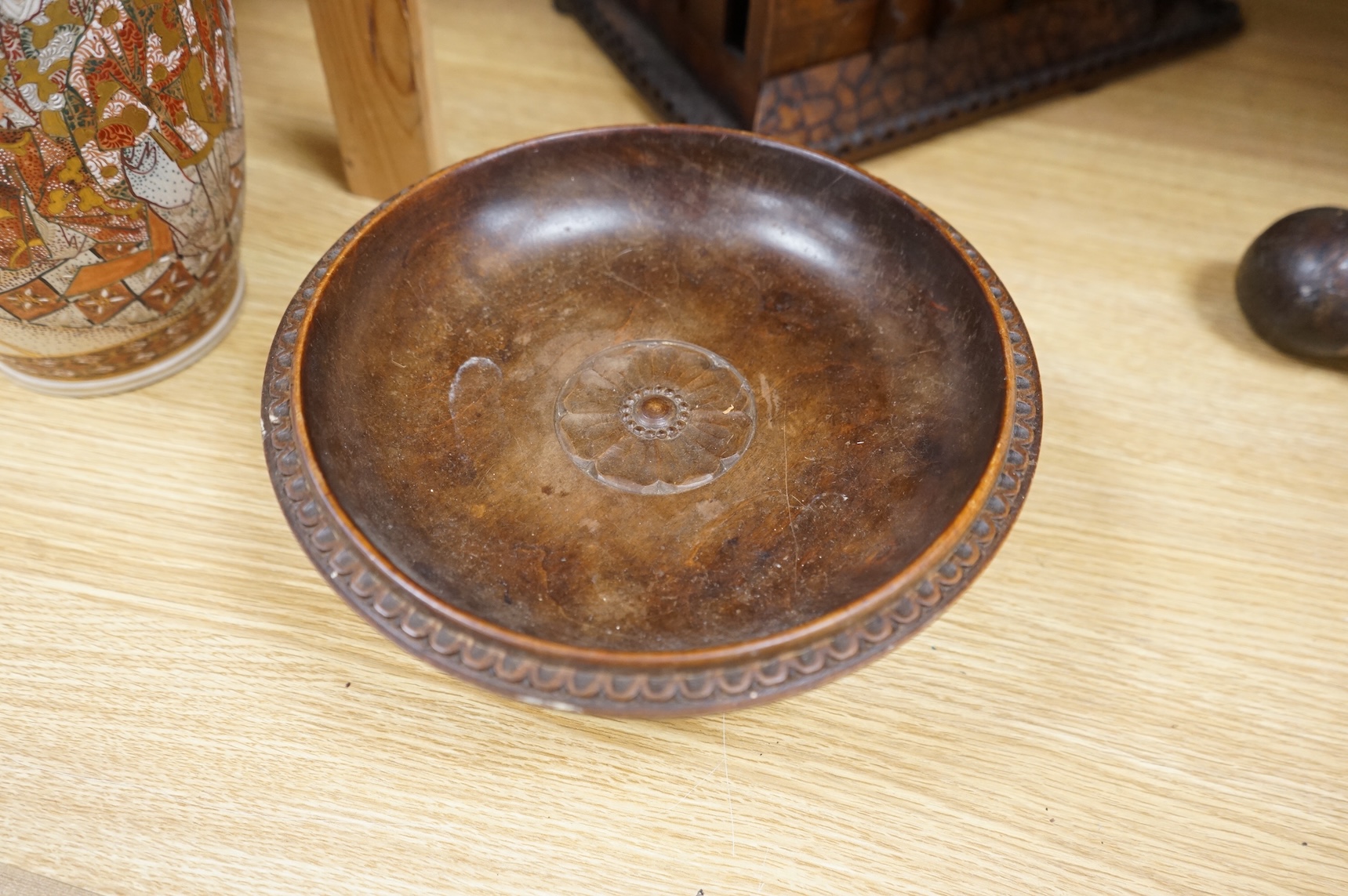 An early 20th century Black Forest carved walnut musical footed dish together with a model of a house (2)